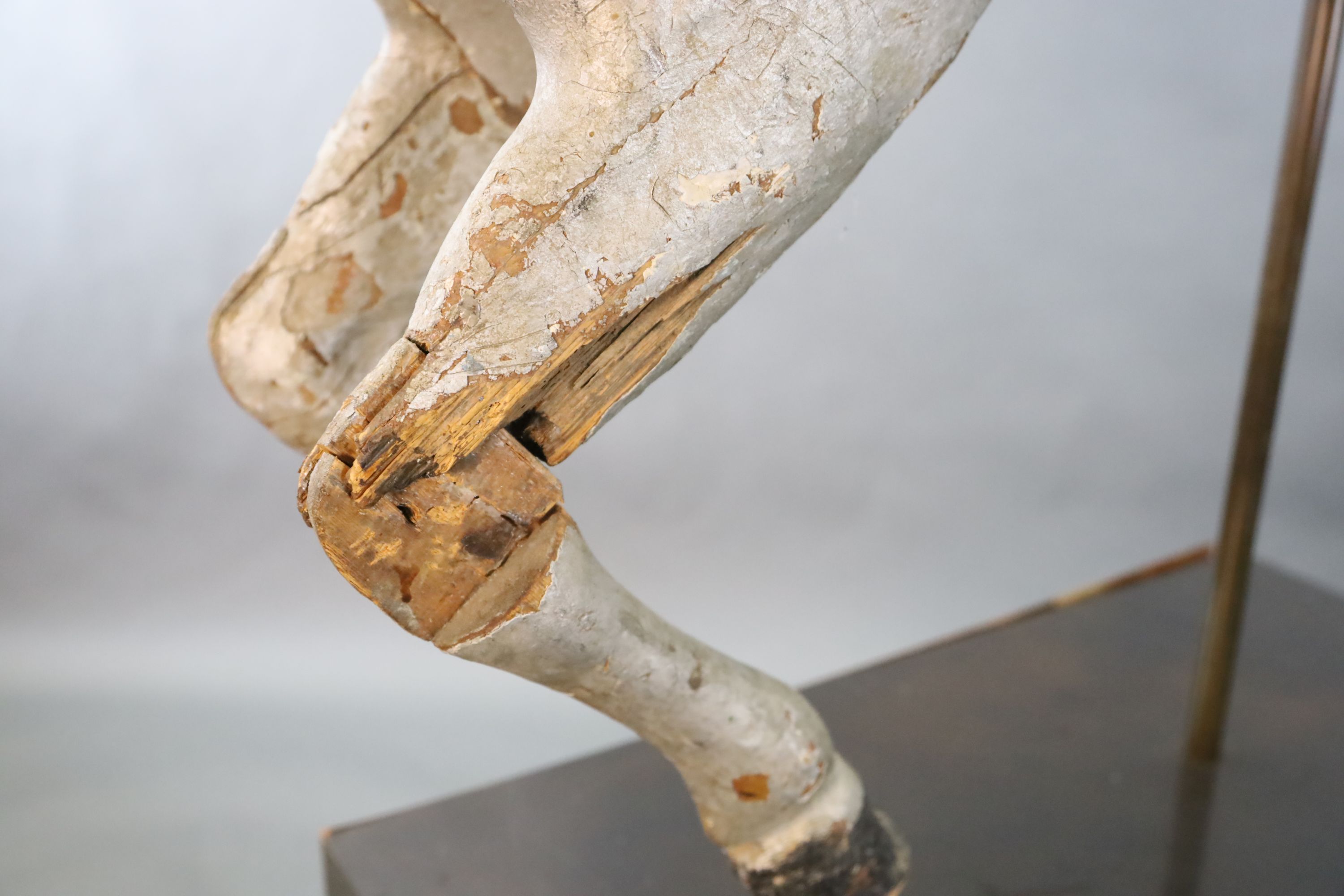 A 19th century, probably American, painted wood carousel horse, L.3ft 5in. H.3ft 7in. Overall H. when on stand 5ft 9in.